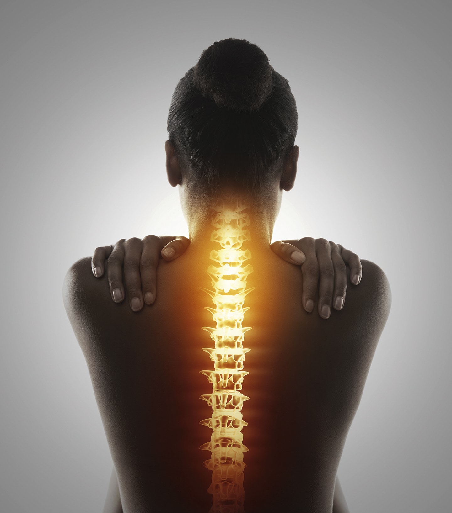 Backpain is a major problem for adults Rearview studio shot of a woman with back discomfort